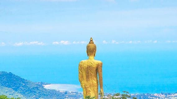 Golden Buddha statue at the highest point of Koh Samui overlooking the sea