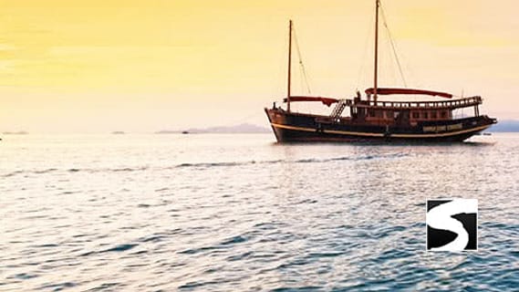 Wooden boat at sunset off the coast of Koh Samui