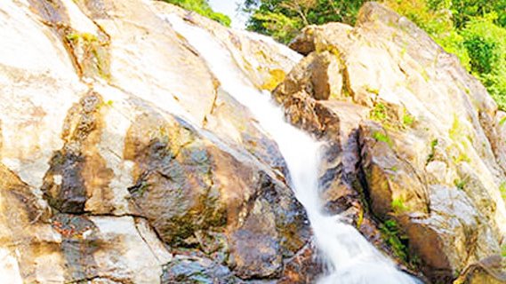 Hin Lad waterfall on Koh Samui flowing between rocks in the jungle